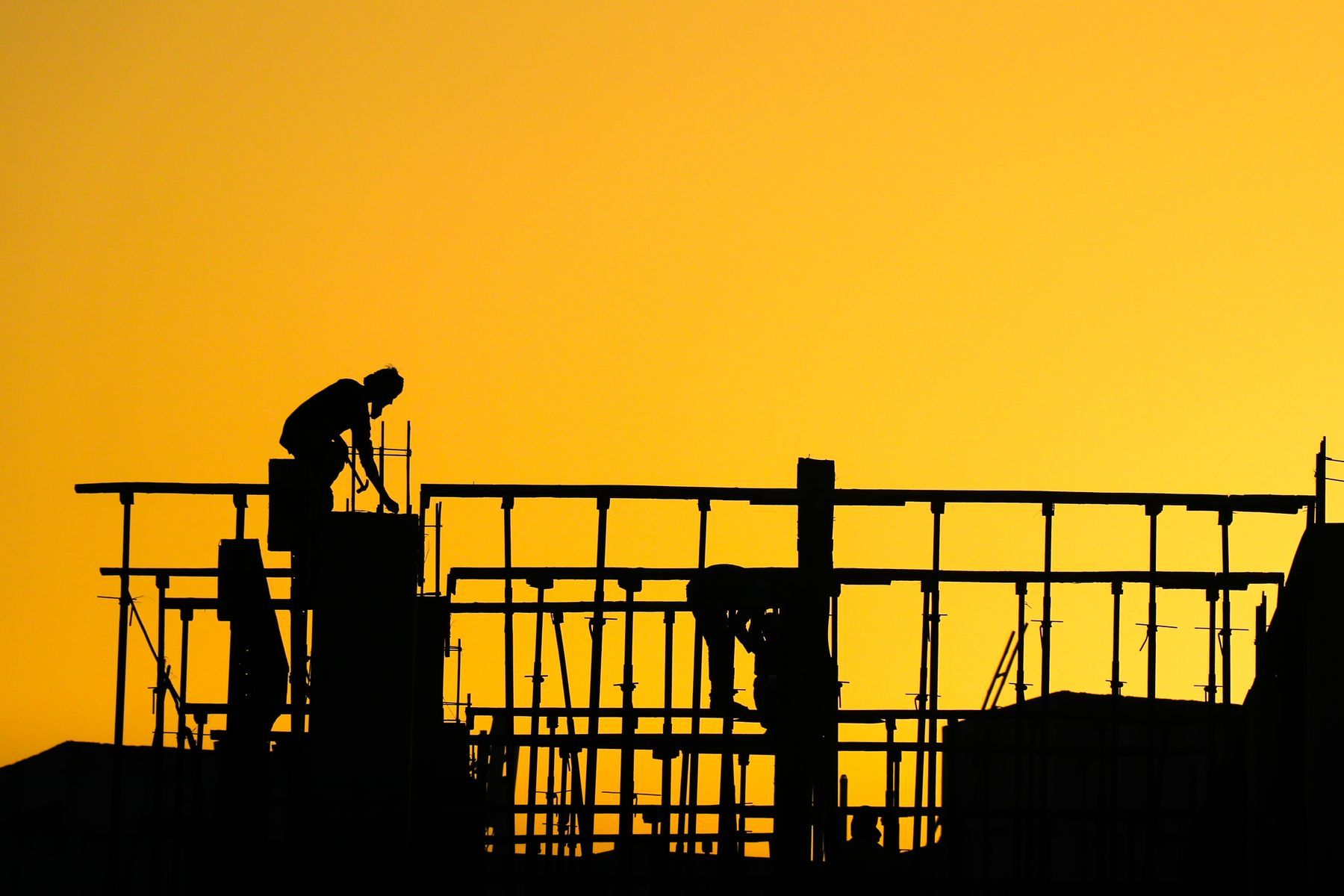 Construction crew at sunset
